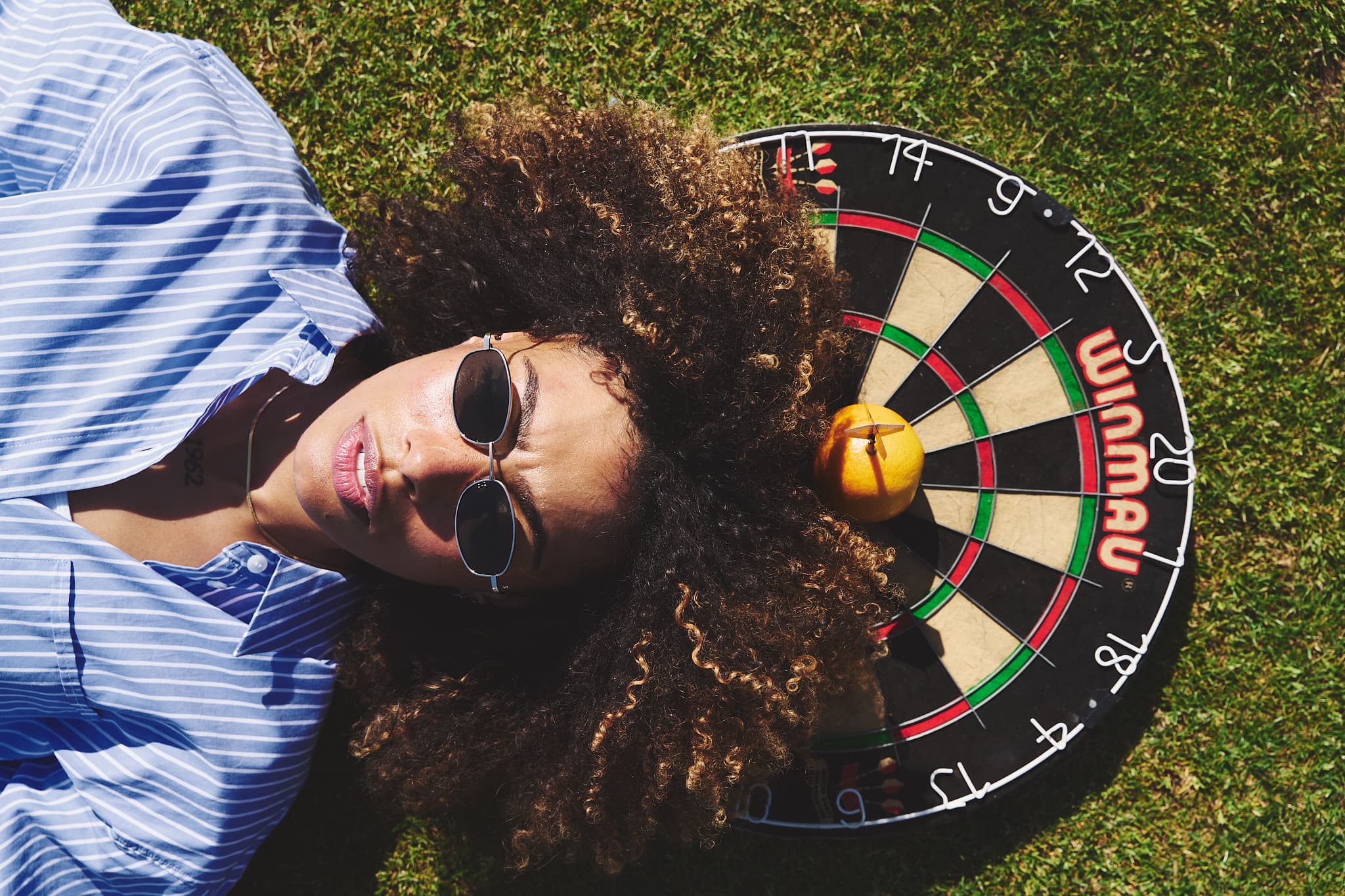 woman laying on a dart board