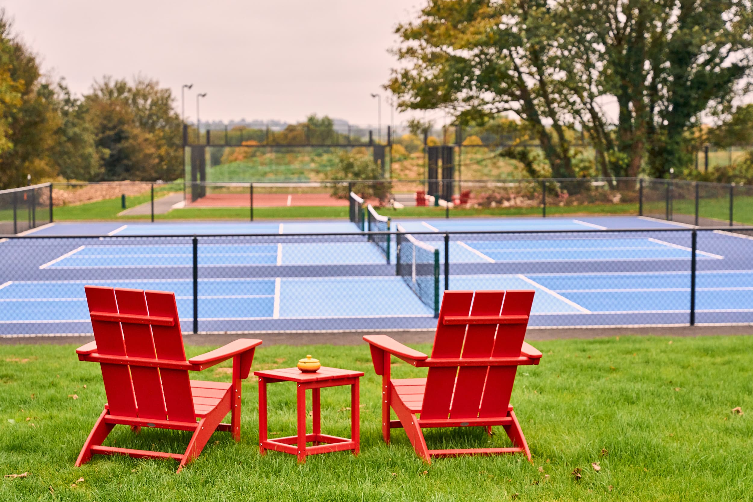 Red chairs pickle ball